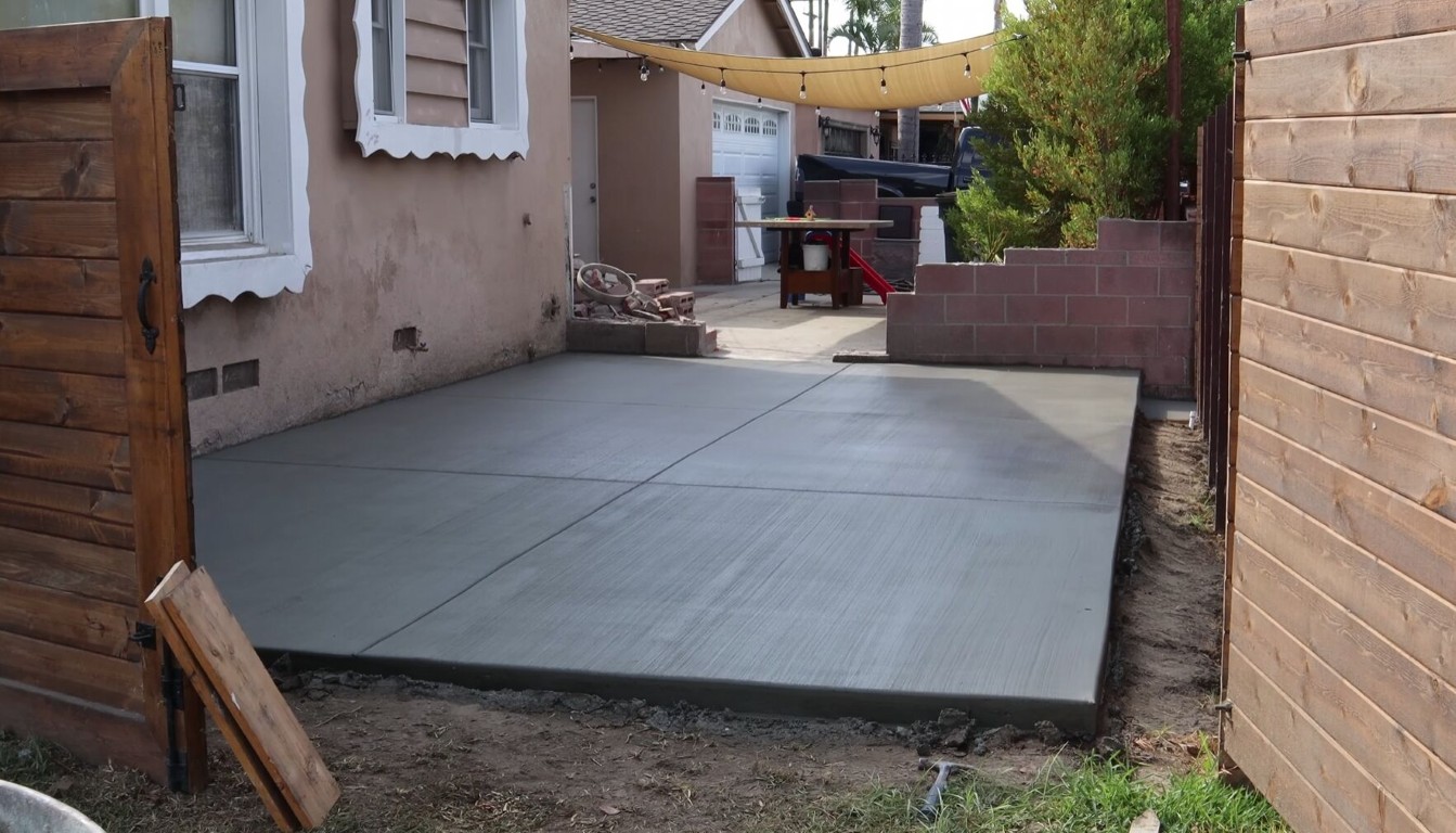 Beautiful concrete patio construction in residential backyard